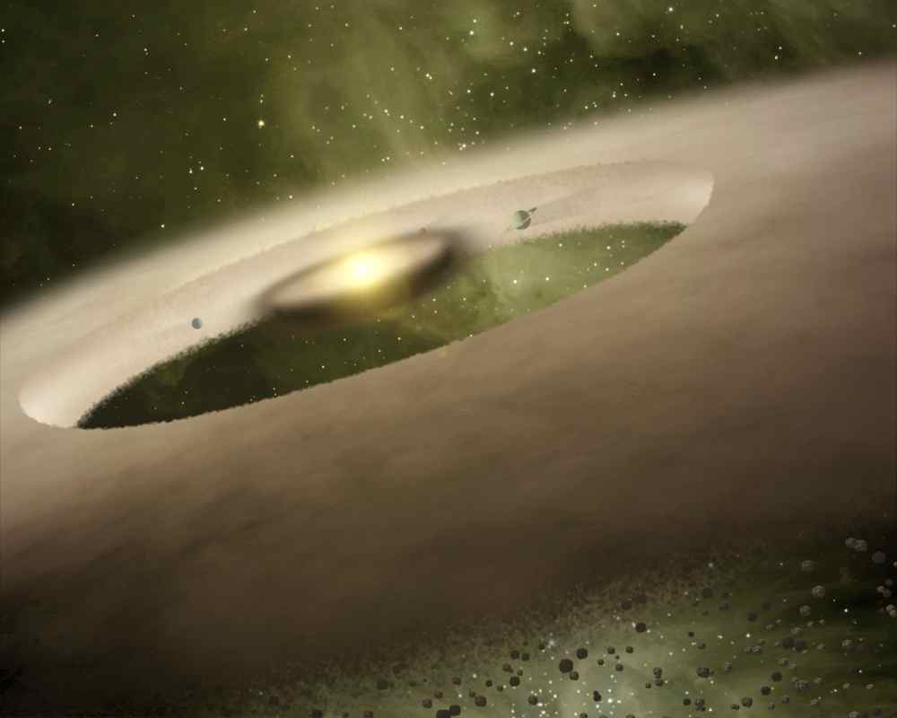 An artist's impression of a donut-shaped "transition disk" around a star, where still-developing planets have carved out a gap in a gassy, dusty, protoplanetary disk. (Credit: NASA/JPL-Caltech)